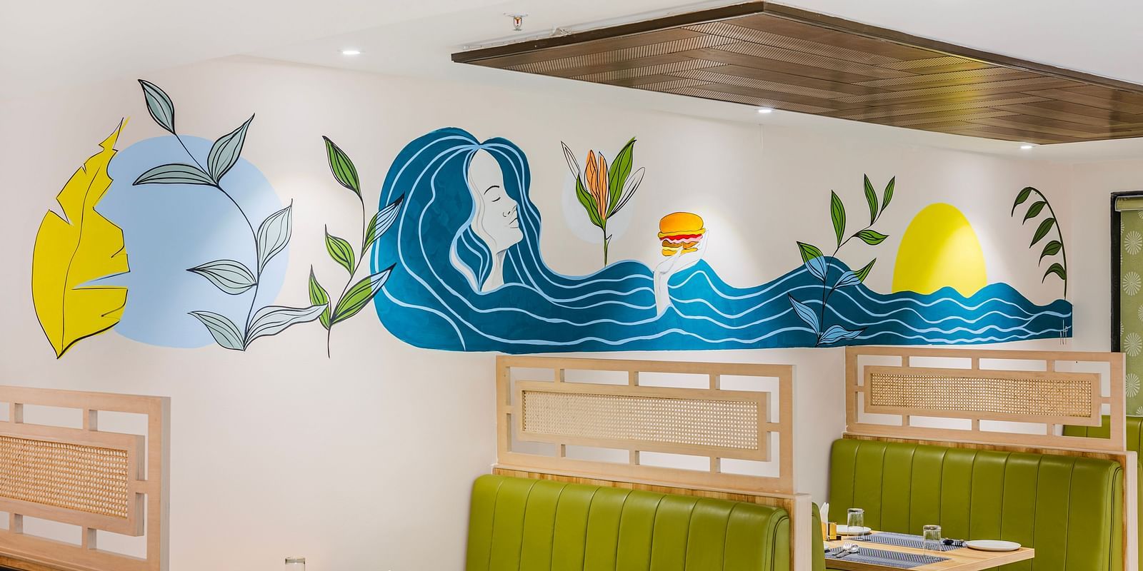 Lemonridge Hotels, KPHB | Close-up of artistic wall decorations in the dining area. Whimsical and colorful designs.